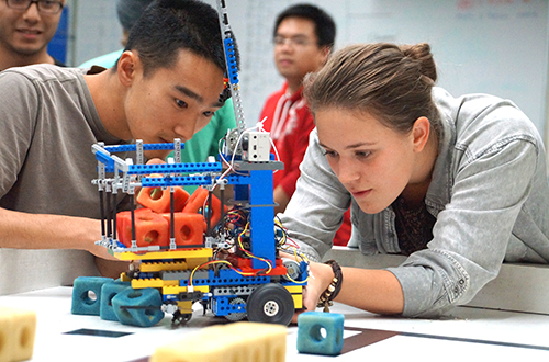 Image of two students collaborating on an mechanical project